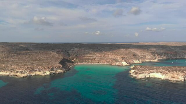 Aerial shot Lampedusa Island (Drone 4k), seagulls, isola dei conigli at sunset - concept of paradise on earth, happiness and travel to beautiful places