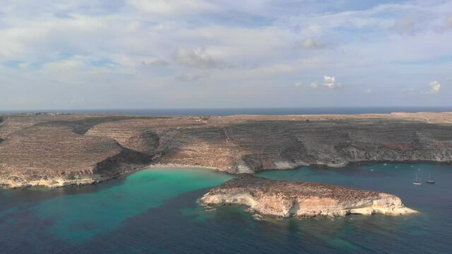 Aerial shot Lampedusa Island (Drone 4k), seagulls, isola dei conigli at sunset - concept of paradise on earth, happiness and travel to beautiful places