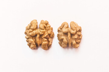 Peeled half open walnuts isolated on white background, close up