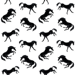 Vector seamless pattern of hand drawn kicking horse silhouette isolated on white background