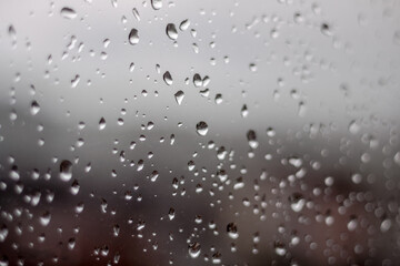 raindrops on window close up. Abstract background rain drop water macro texture. 