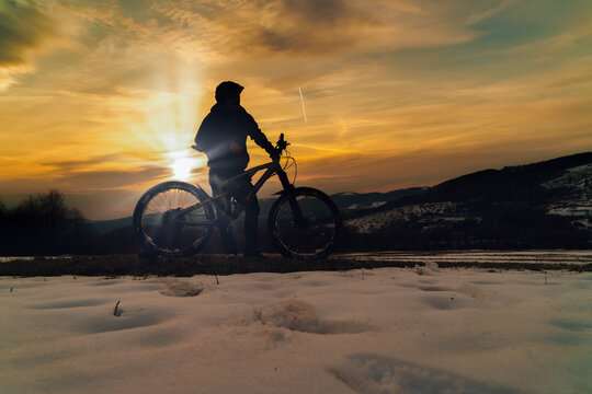 silhouette of a person with a bike