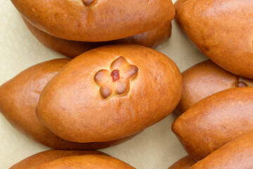 Buns with a flower made from dough and jam. A crispy crust on baked goods. Top view.