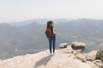 girl with backpack in the mountain