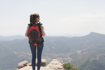 girl with backpack in the mountain