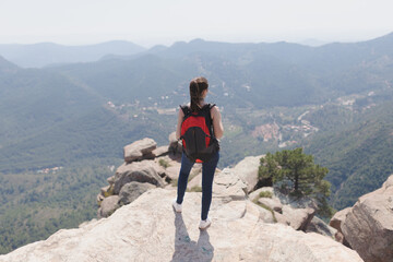 girl with backpack in the mountain