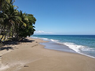 Lush Tropical Beach Paradise with blue water, great waves and rock formations in Montezuma Nicoya Peninsula Costa Rica