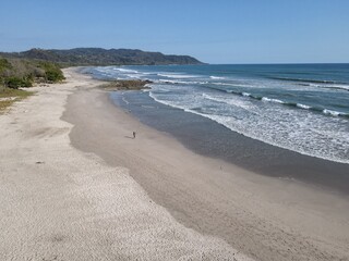 Lush Tropical Beach Paradise with blue water, great waves and rock formations in Malpais / Santa Teresa, Nicoya Peninsula Costa Rica