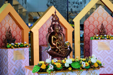Brown sitting Buddha images displayed for people to pay respect during annual splash water festival in Thailand