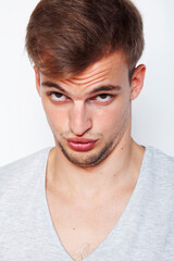 Obraz premium young handsome teenage hipster guy posing emotional, happy smiling against white background isolated, lifestyle people concept