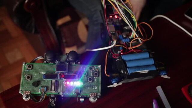DIY, the machine. Home experiments, robotics, smart engineer. Toy for the child. glowing remote control. Motherboard, tools for creating electronic devices. Technical discussion, future technologies