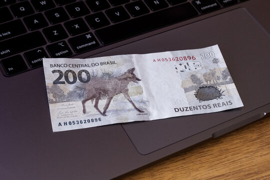 200 reais bank note on notebook - Economic crisis in Brazil - Brazilian economy - Dinheiro do Brasil - Brazilian currency