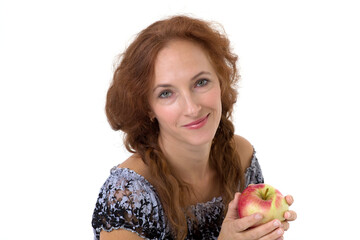 Happy woman holding fresh red apple. Photo session in the studio