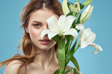 Attractive Lady white flowers blue background portrait cropped view