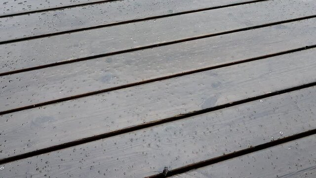 Rain falling on a wooden deck