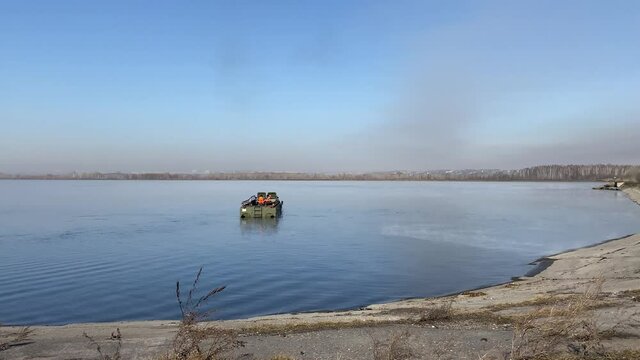 Novokuznetsk, Russia-April 2020: An amphibious rescue vehicle comes ashore from the water.