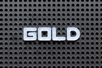 White color letter in word gold on black pegboard background