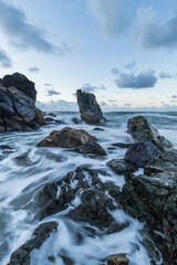 Fototapeta premium Ocean water flowing between rocks.