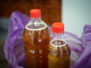 A salesman in a supermarket holds a pack of beer in his hands.