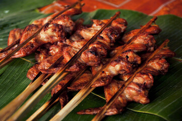 Lao Grilled Chicken Wings (Ping Gai) on skewers for sale on the street of Vientiane, Laos. 