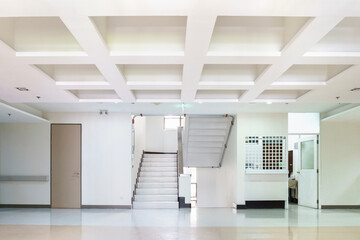 Interior of a building with white color walls. Flight of stairs.