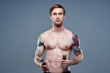 Fototapeta premium handsome man blond Sport Fitness pumped-up torso dumbbells model