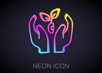 Glowing neon line Plant in hand of environmental protection icon isolated on black background. Seed and seedling. Planting sapling. Ecology concept. Vector