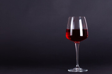 Glass of wine on a lilac background.With space for text. Wine tasting and drinking culture concept.