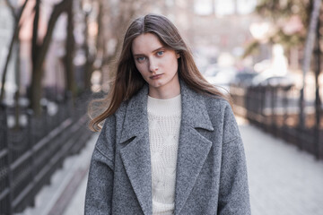 Portrait of an attractive girl on the street while walking