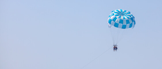 A parachute with people flies