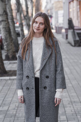 Fototapeta premium Portrait of an attractive girl on the street while walking