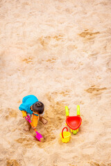 The little boy was playing in the sand at the beach