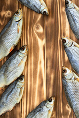 dry fish on a wooden background with space for text.