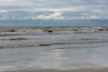 Winter seashore with clouds and waves