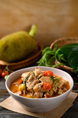 Northern Thai food (Kang Kanoon), Spicy young jackfruit soup with pork in a bowl on wooden table
