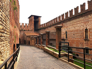 Old, brick bridge near the museum of Castelvecchio. Walking path through the museum of...