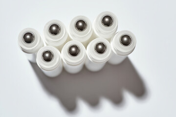 Top view of tubes for eye roller beauty product isolated over white background with reflection