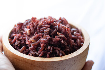 Close-up. Riceberry rice in a wooden bowl.