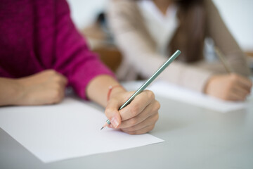 Teenage student writing down.