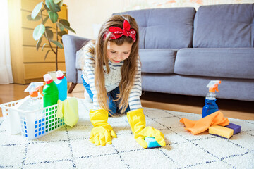 Cleaning the room, cleaning. Child girl washes and cleans the house of viruses and coronavirus. Cleanliness and order