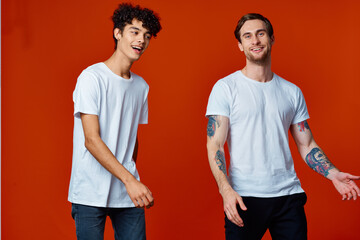 Two cheerful men on t-shirts communication friendship red background