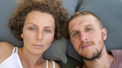 Portrait of young caucasian couple staring to the camera.