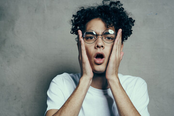 guy with curly hair emotions glasses fashion studio close-up