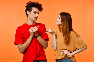 cheerful young couple lifestyle studio orange background cropped view