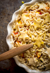 Pie with berries and peaches is greased with egg before baking