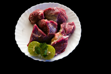 Fresh Beef Steaks decorated with vegetables and herbs on a white plate,Selective focus.
