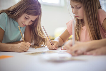 Two girl working exam together.