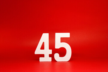 Forty Five ( 45 ) white number wooden Isolated Red Background with Copy Space - New promotion 45% Percentage  Business finance Concept 