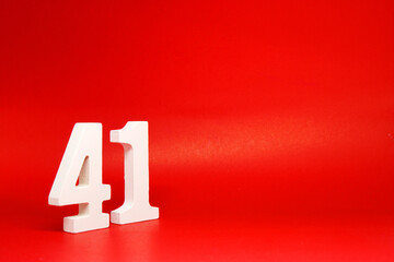 Forty One ( 41 ) white number wooden Isolated Red Background with Copy Space - New promotion 41% Percentage  Business finance Concept  - obrazy, fototapety, plakaty