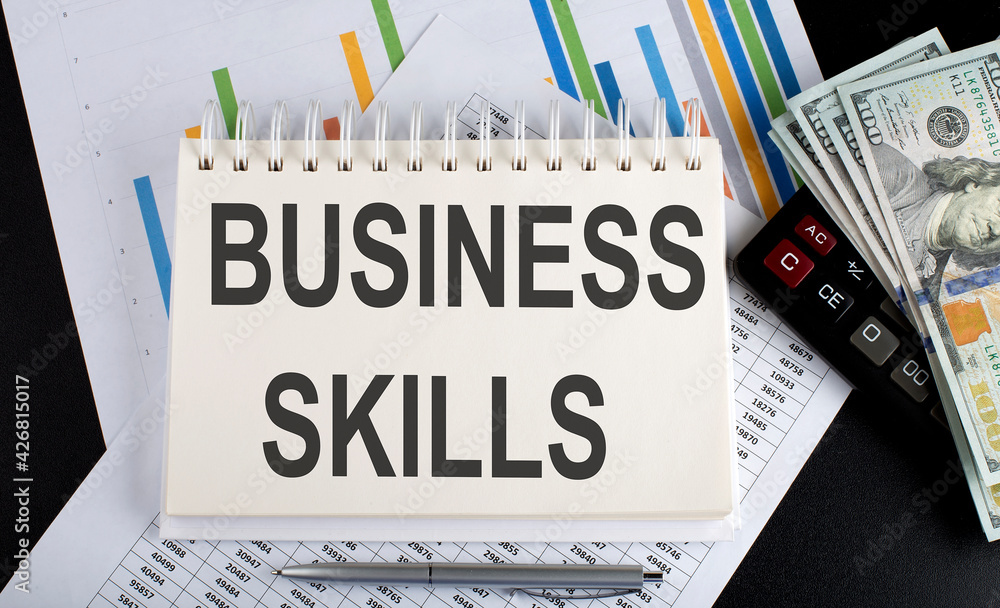 Poster business skills text written on notebook with chart,calculator and dollars
